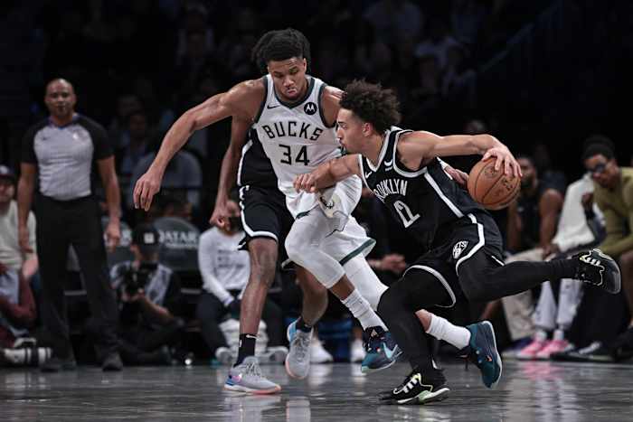 Brooklyn Nets forward Jalen Wilson (22) dribbles against Milwaukee Bucks forward Giannis Antetokounmpo (34) 