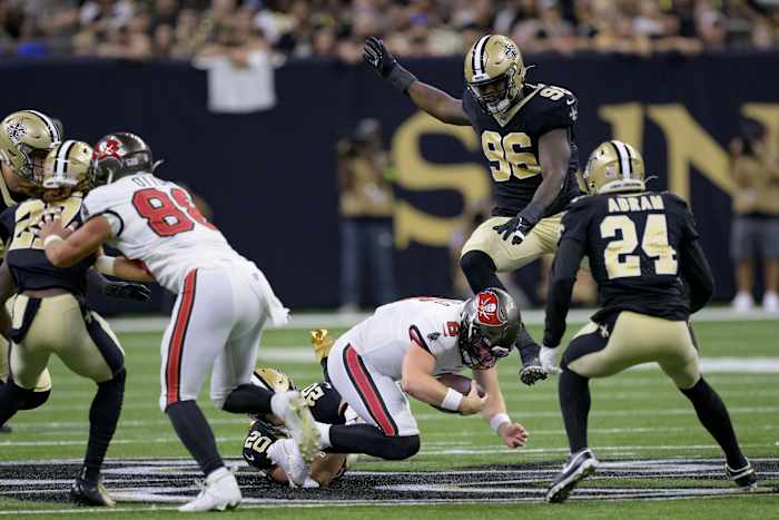 Tampa Bay Buccaneers quarterback Baker Mayfield (6) is brought down by New Orleans Saints linebacker Pete Werner (20) and defensive end Carl Granderson (96). Mandatory Credit: Matthew Hinton-USA TODAY Sports