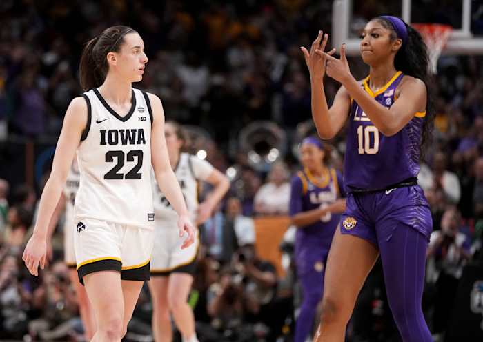 LSU Tigers forward Angel Reese celebrates in front of Iowa Hawkeyes guard Caitlin Clark.