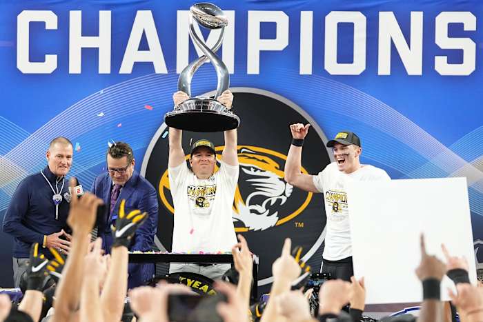 Missouri Tigers head coach Eliah Drinkwitz hoists the Field Scovell Trophy following their 14-3 win over the Ohio State Buckeyes in the Goodyear Cotton Bowl Classic at AT&T Stadium.