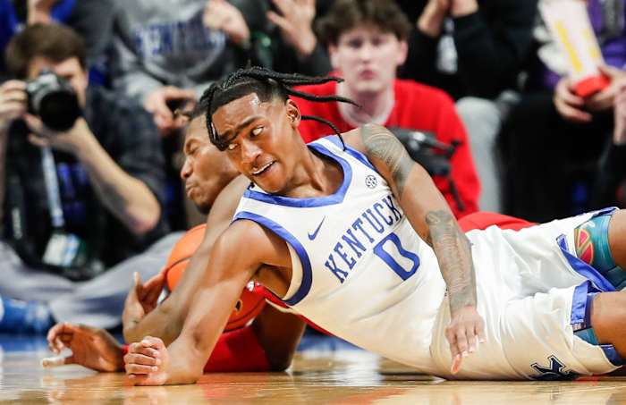 Kentucky Wildcats guard Rob Dillingham (0) battles Illinois State Redbirds forward Myles Foster (4) for control in the first half at Rupp Arena Friday night in Lexington, Ky. Dec. 29, 2023