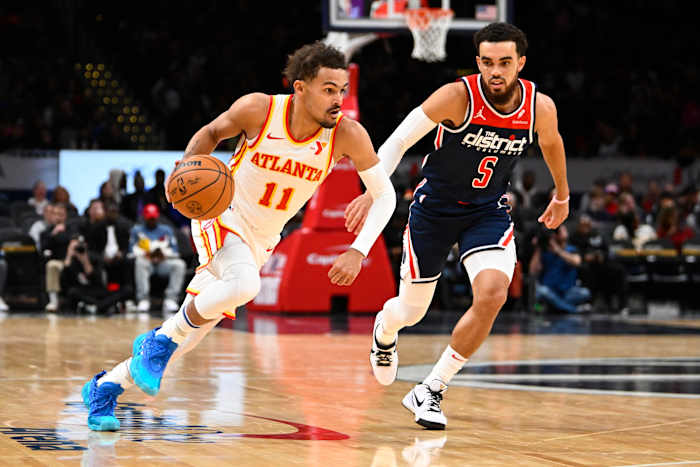 Nov 25, 2023; Washington, District of Columbia, USA; Atlanta Hawks guard Trae Young (11) advances the ball as Washington Wizards guard Tyus Jones (5) looks on during the first half at Capital One Arena. Mandatory Credit: Brad Mills-USA TODAY Sports