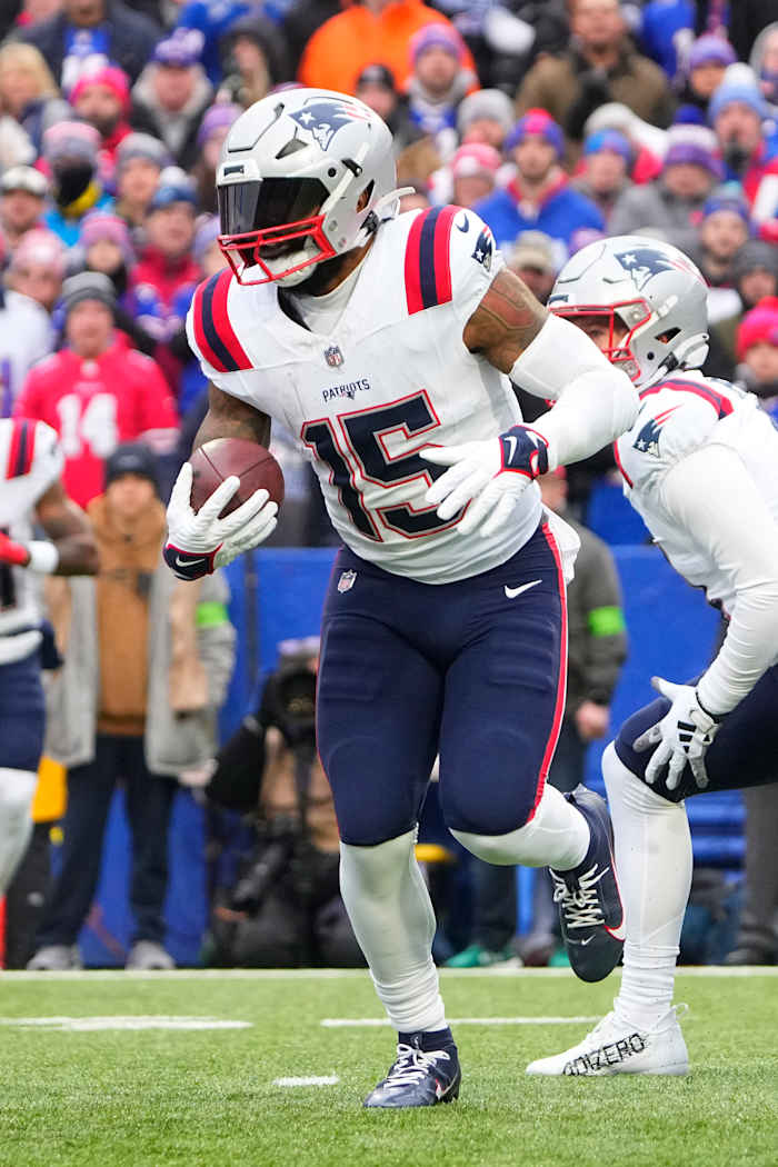 New England Patriots running back Ezekiel Elliott (15) runs with the ball against the Buffalo Bills during the first half at Highmark Stadium.