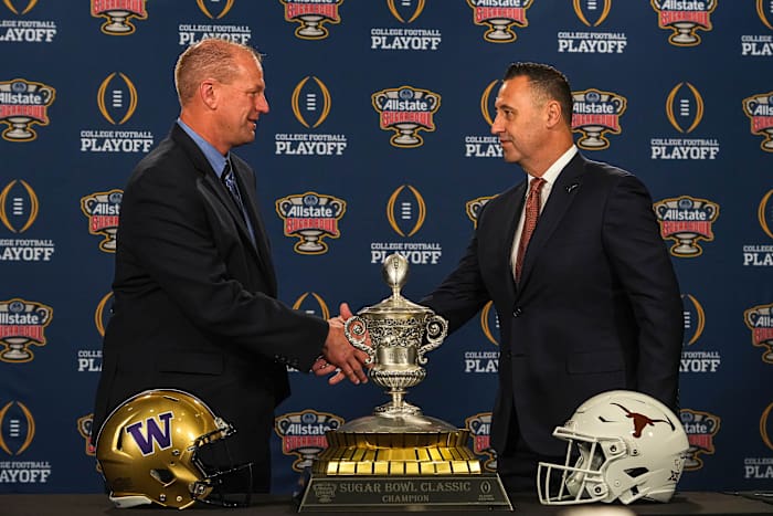 Washinton Huskies head coach Kalen DeBoer, left, meets Texas Longhorns head coach Steve Sarkisian, right, at the head coaches' press conference at the Sheraton hotel on Sunday, Dec. 31, 2023 in New Orleans, Louisiana. The Washington Huskies will take on the Texas longhorns in the College Football Playoff Semi-Finals on January 1, 2024.