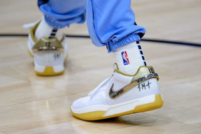 Memphis Grizzlies guard Ja Morant's white and gold Nike sneakers.