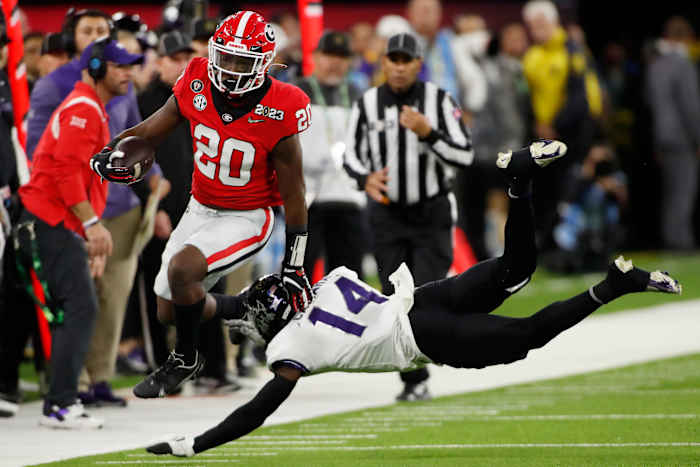 Georgia running back Sevaughn Clark (20) hurdles TCU safety Abraham Camara (14) during the second half of the NCAA College Football National Championship game between TCU and Georgia on Monday, Jan. 9, 2023, in Inglewood, Calif. (Joshua L. Jones / USA TODAY NETWORK).