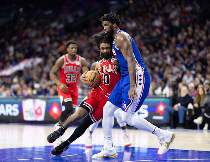 Chicago Bulls guard Coby White (0) drives against Philadelphia 76ers center Joel Embiid (21) during the third quarter at Wells Fargo Center.