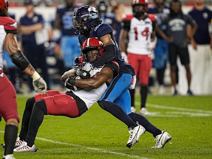 Aug 20, 2022; Toronto, Ontario, CAN; Toronto Argonauts linebacker Wynton McManis (48) tackles Calgary Stampeders running back Dedrick Mills (34) during the second half at BMO Field. Mandatory Credit: John E. Sokolowski-USA TODAY Sports