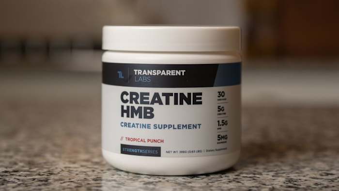 White tub with blue writing that reads "CREATINE HMB" on a marble countertop