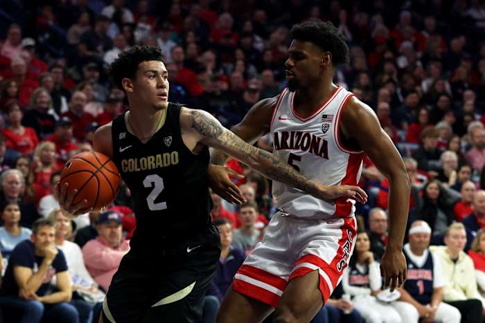 Colorado Buffaloes guard KJ Simpson (2) gets a rebound against Arizona Wildcats guard KJ Lewis (5) during the second half at McKale Center