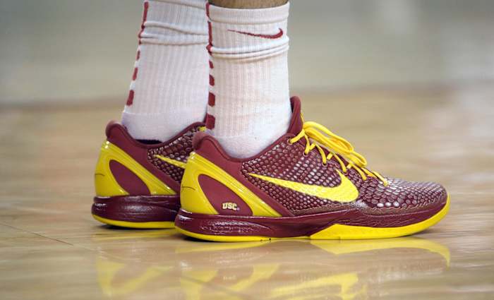 USC Trojans' cardinal and gold Nike Kobe sneakers.
