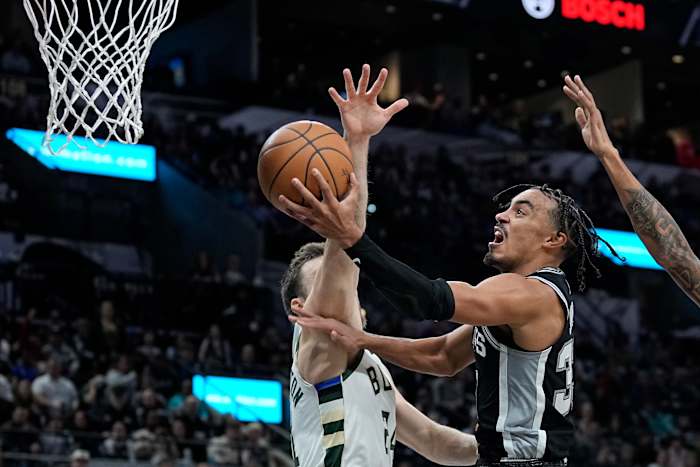 Jan 4, 2024; San Antonio, Texas, USA; San Antonio Spurs guard Tre Jones (33) drives to the basket while defended by Milwaukee Bucks guard Pat Connaughton (8) during the second half at Frost Bank Center.