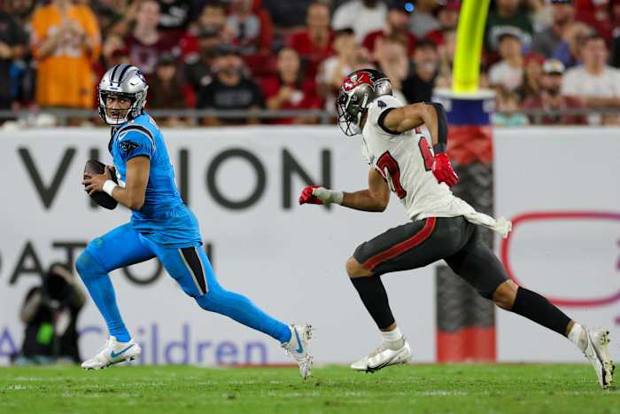 Carolina Panthers quarterback Bryce Young (9) is chased by Tampa Bay Buccaneers cornerback Zyon McCollum (27) in the fourth quarter at Raymond James Stadium.