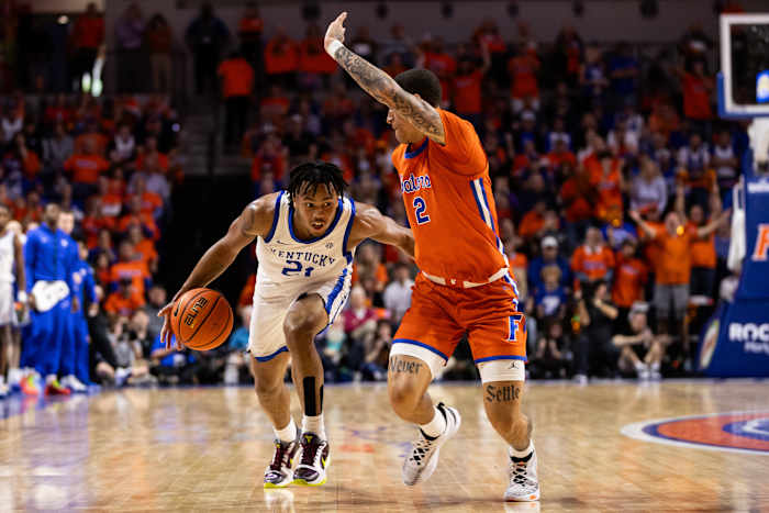 Jan 6, 2024; Gainesville, Florida, USA; Kentucky Wildcats guard D.J. Wagner (21) dribbles the ball at Florida Gators guard Riley Kugel (2) during the first half at Exactech Arena at the Stephen C. O'Connell Center. Mandatory Credit: Matt Pendleton-USA TODAY Sports