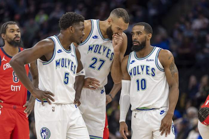 Jan 3, 2024; Minneapolis, Minnesota, USA; Minnesota Timberwolves guard Anthony Edwards (5), center Rudy Gobert (27) and guard Mike Conley (10) talk during a free throw against the New Orleans Pelicans in the first half at Target Center.