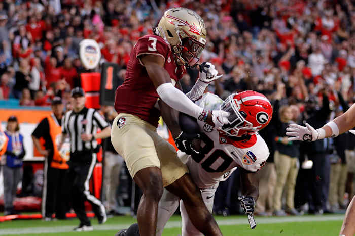 Dec 30, 2023; Miami Gardens, FL, USA; Georgia Bulldogs running back Daijun Edwards (30) scores a touchdown against Florida State Seminoles defensive back Kevin Knowles II (3) during the first half in the 2023 Orange Bowl at Hard Rock Stadium. (Sam Navarro / USA TODAY Sports).