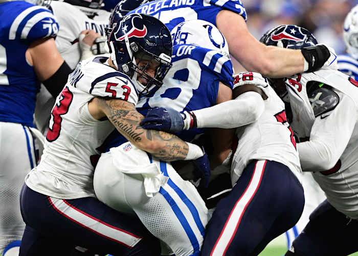 Texans linebacker Blake Cashman grimaces as he helps to tackle Indianapolis Colts running back Jonathan Taylor (28) during the second half at Lucas Oil Stadium.