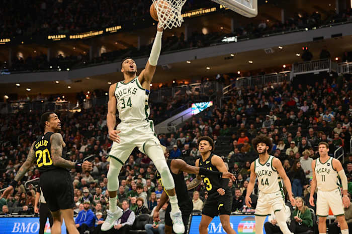 Milwaukee Bucks forward Giannis Antetokounmpo (34) scores a basket against Utah Jazz forward John Collins (20)