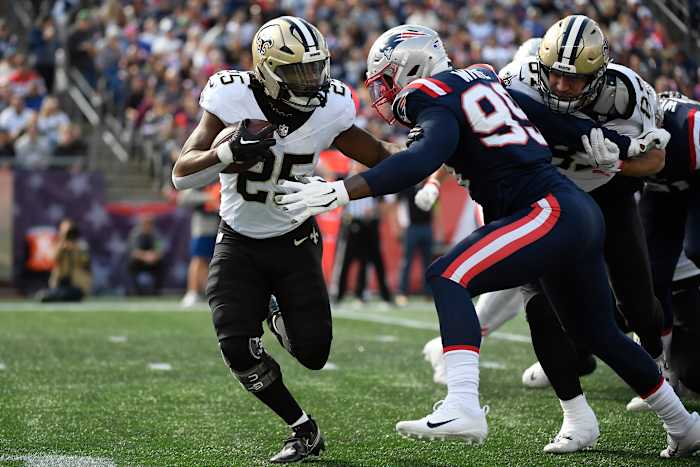 Oct 8, 2023; Foxborough, Massachusetts, USA; New England Patriots defensive end Keion White (99) tackles New Orleans Saints running back Kendre Miller (25) during the first half at Gillette Stadium. Mandatory Credit: Bob DeChiara-USA TODAY Sports