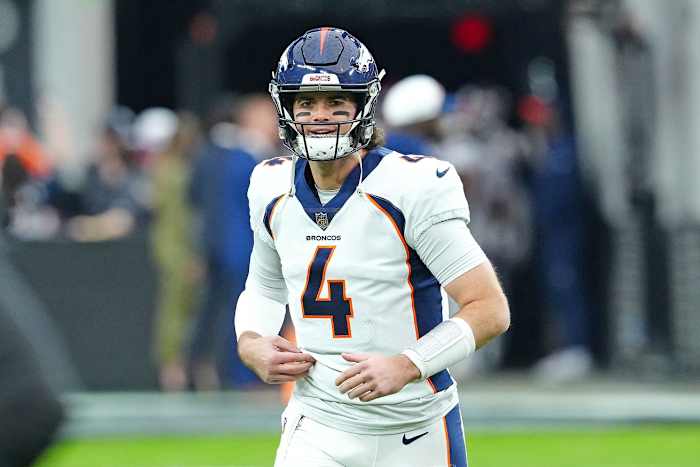 Denver Broncos quarterback Jarrett Stidham (4) takes the field to warm up before a game against the Las Vegas Raiders at Allegiant Stadium.