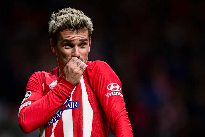 Antoine Griezmann pictured kissing the Atletico Madrid crest on his jersey after scoring a goal in a 2-0 win over Lazio in December 2023