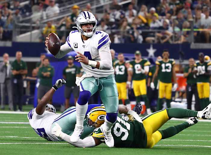Oct 6, 2019; Arlington, TX, USA; Dallas Cowboys quarterback Dak Prescott (4) scrambles in the fourth quarter against Green Bay Packers linebacker Preston Smith (91) at AT&T Stadium.