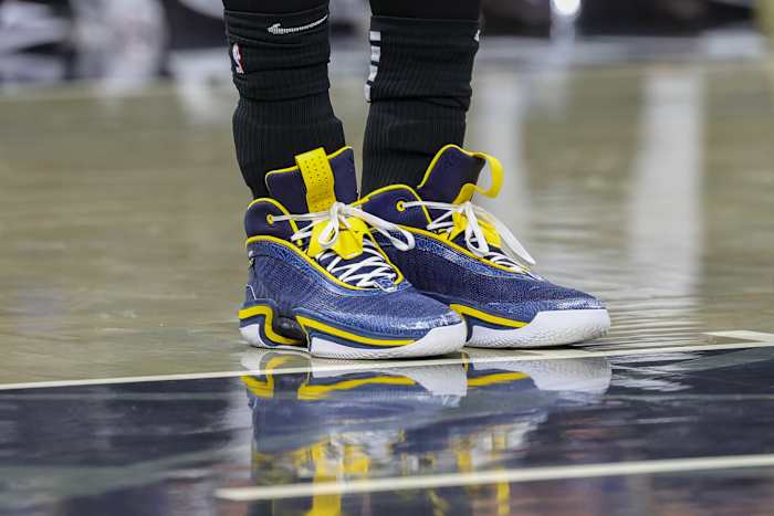 Orlando Magic center Moritz Wagner's navy and maize Air Jordan sneakers.