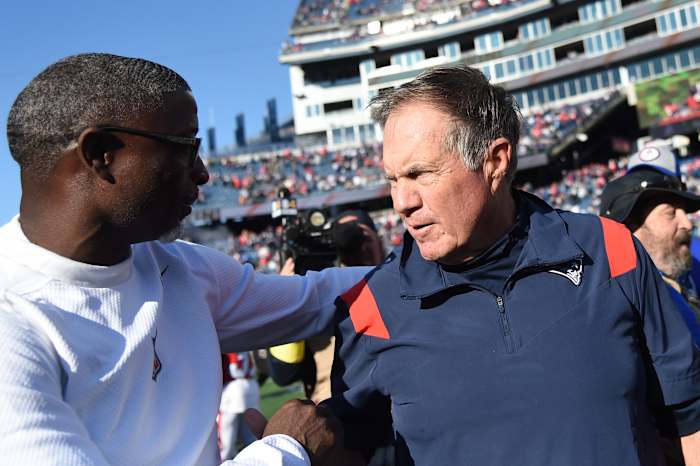 Oct 9, 2022; Foxborough, Massachusetts, USA; New England Patriots head coach Bill Belichick and Detroit Lions defensive coordinator Aaron Glenn meet at midfield at Gillette Stadium.