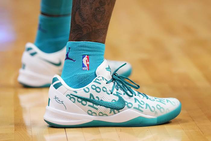 Charlotte Hornets guard Terry Rozier's white and teal Nike Kobe sneakers.