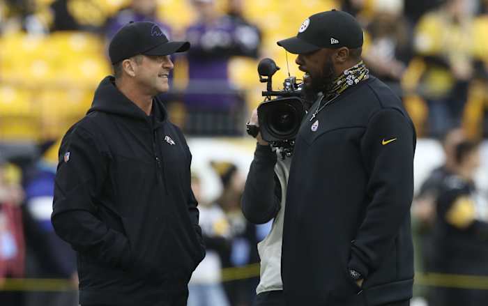Dec 5, 2021; Pittsburgh, Pennsylvania, USA; Baltimore Ravens head coach John Harbaugh (left) and Pittsburgh Steelers head coach Mike Tomlin (right) talk on the field before their teams play at Heinz Field.