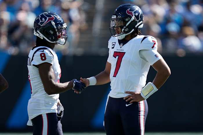 Houston Texans wide receiver John Metchie III (8) shakes hands with quarterback C.J. Stroud (7) during a time out to check for a touchdown run during the second quarter against the Carolina Panthers at Bank of America Stadium.