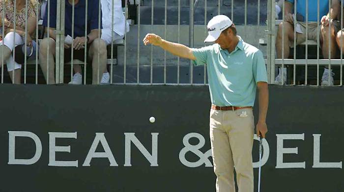 A player takes a drop away from a grandstand in 2017 at Colonial Country Club in Fort Worth, Texas.
