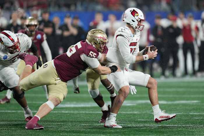 Dec 2, 2023; Charlotte, NC, USA; Florida State Seminoles defensive lineman Braden Fiske (55) sacks Louisville Cardinals quarterback Jack Plummer (13) during the fourth quarter at Bank of America Stadium. Mandatory Credit: Jim Dedmon-USA TODAY Sports