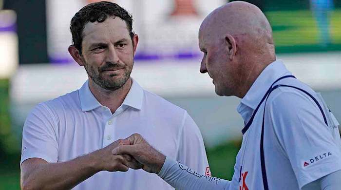 Patrick Cantlay, left, bumps fists with caddie Joe LaCava on the 18th green during the final round of the 2023 St. Jude Championship.