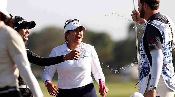 Patty Tavatanakit, left, celebrates with tournament winner Lilia Vu, center, and Vu's caddie, right, following the final round of the Annika on Sunday, Nov. 12, 2023, in Belleair, Fla.