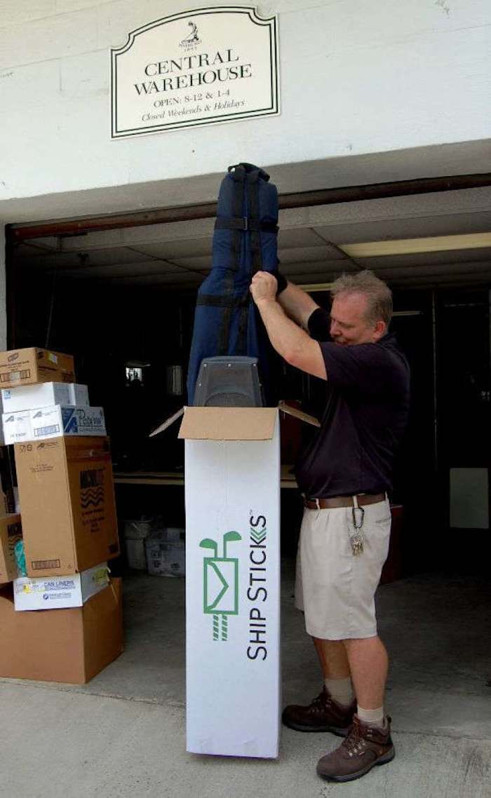 A Pinehurst Resort and Country Club baggage handler readies a golf bag for play after being delivered from Ship Sticks.