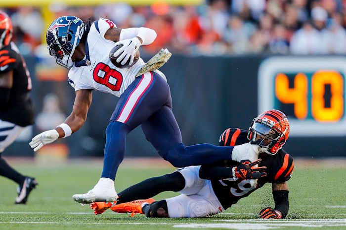 Texans wide receiver John Metchie III runs with the ball against Cincinnati Bengals cornerback Cam Taylor-Britt (29) in the second half at Paycor Stadium.
