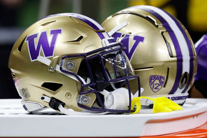 an 1, 2024; New Orleans, LA, USA; Washington Huskies players' helmets rest on a cooler on the bench against the Texas Longhorns in the 2024 Sugar Bowl college football playoff semifinal game at Caesars Superdome. Mandatory Credit: Geoff Burke-USA TODAY Sports