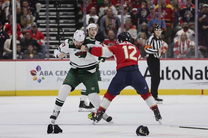Jan 19, 2024; Sunrise, Florida, USA; Minnesota Wild left wing Marcus Foligno (17) and Florida Panthers left wing Jonah Gadjovich (12) fight during the first period at Amerant Bank Arena.