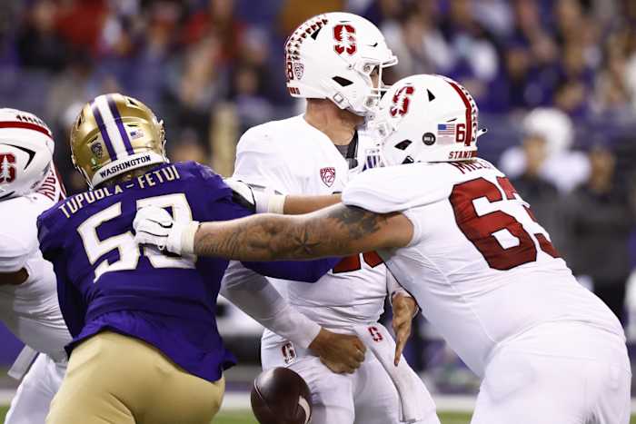 Sep 24, 2022; Seattle, Washington, USA; Washington Huskies defensive lineman Zion Tupuola-Fetui (58) forces a fumble by Stanford Cardinal quarterback Tanner McKee (18) during the fourth quarter at Alaska Airlines Field at Husky Stadium. Mandatory Credit: Joe Nicholson-USA TODAY Sports  