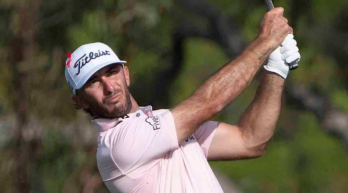 Max Homa is pictured hitting from the fairway at the 2024 Sentry Tournament of Champions at Kapalua's Plantation Course.