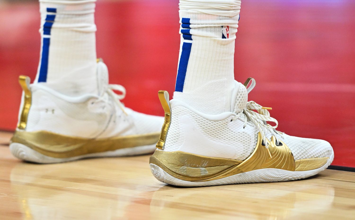 Philadelphia 76ers center Joel Embiid's white and gold Under Armour shoes.