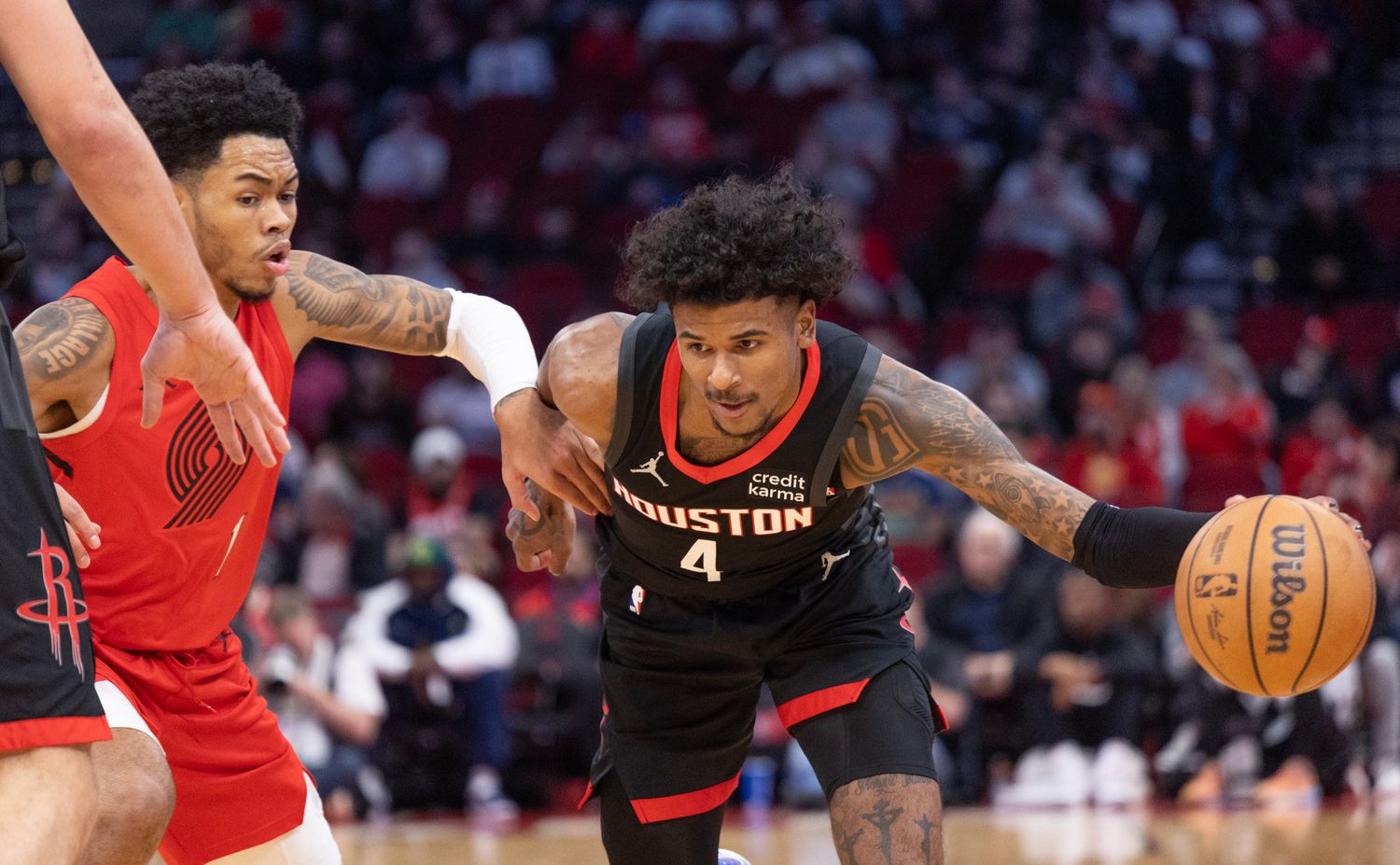 Rockets guard Jalen Green dribbles against Portland Trail Blazers guard Anfernee Simons (1) in the first quarter at Toyota Center.