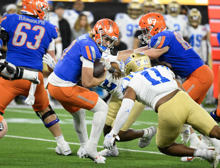 Dec 16, 2023; Inglewood, CA, USA; Boise State Broncos quarterback CJ Tiller (0) is sacked by UCLA Bruins defensive lineman Hayden Nelson (52) and defensive lineman Gabriel Murphy (11) during the fourth quarter of the Starco Brands LA Bowl at SoFi Stadium. Mandatory Credit: Robert Hanashiro-USA TODAY Sports