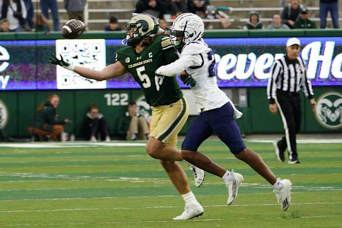 Nov 18, 2023; Fort Collins, Colorado, USA; Colorado State Rams tight end Dallin Holker (5) tries in vain to make a catch with Nevada Wolf Pack defensive back Chad Brown (24) holding him at Sonny Lubick Field at Canvas Stadium. Mandatory Credit: Michael Madrid-USA TODAY Sports