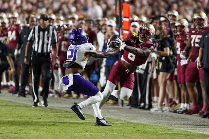 Nov 18, 2023; Tallahassee, Florida, USA; Florida State Seminoles tight end Jaheim Bell (6) catches the ball under pressure from North Alabama Lions linebacker Ashaad Williams (21) during the third quarter at Doak S. Campbell Stadium. Mandatory Credit: Morgan Tencza-USA TODAY Sports