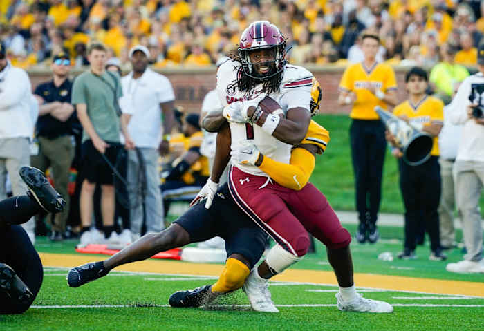 Oct 21, 2023; Columbia, Missouri, USA; South Carolina Gamecocks tight end Trey Knox (1) is tackled by Missouri Tigers defensive back Jaylon Carlies (1) during the second half at Faurot Field at Memorial Stadium. Mandatory Credit: Jay Biggerstaff-USA TODAY Sports