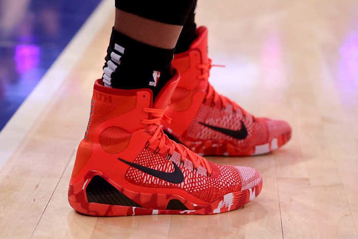 Side view of Kobe Bryant's red and black Nike sneakers.