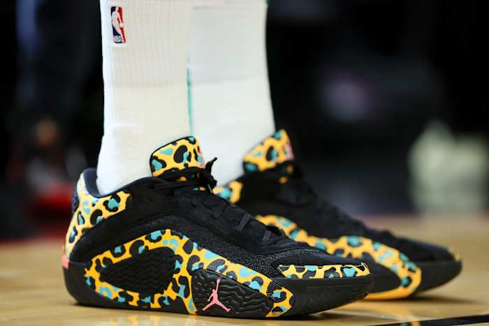 Boston Celtics forward Jayson Tatum's black and gold Jordan Brand sneakers.