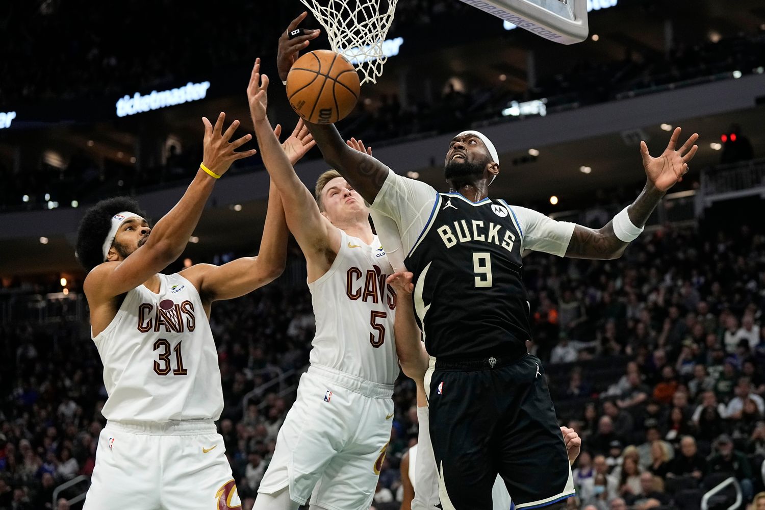 Jan 26, 2024; Milwaukee, Wisconsin, USA; Milwaukee Bucks forward Bobby Portis (9) reaches for a rebound in front of Cleveland Cavaliers center Jarrett Allen (31) and guard Malik Beasley (5) during the second quarter at Fiserv Forum. Mandatory Credit: Jeff Hanisch-USA TODAY Sports